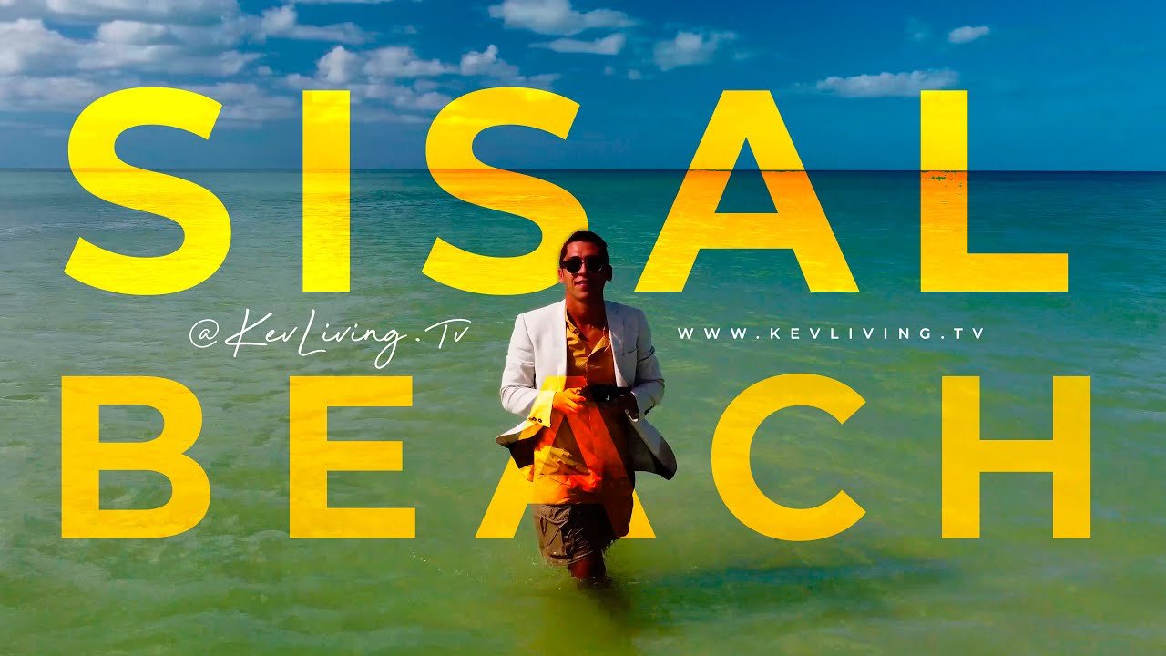 Kev Living in Sisal, Yucatán, standing on the beach with “SISAL BEACH” text, representing a territory first real estate agent focused on coastal micro zones